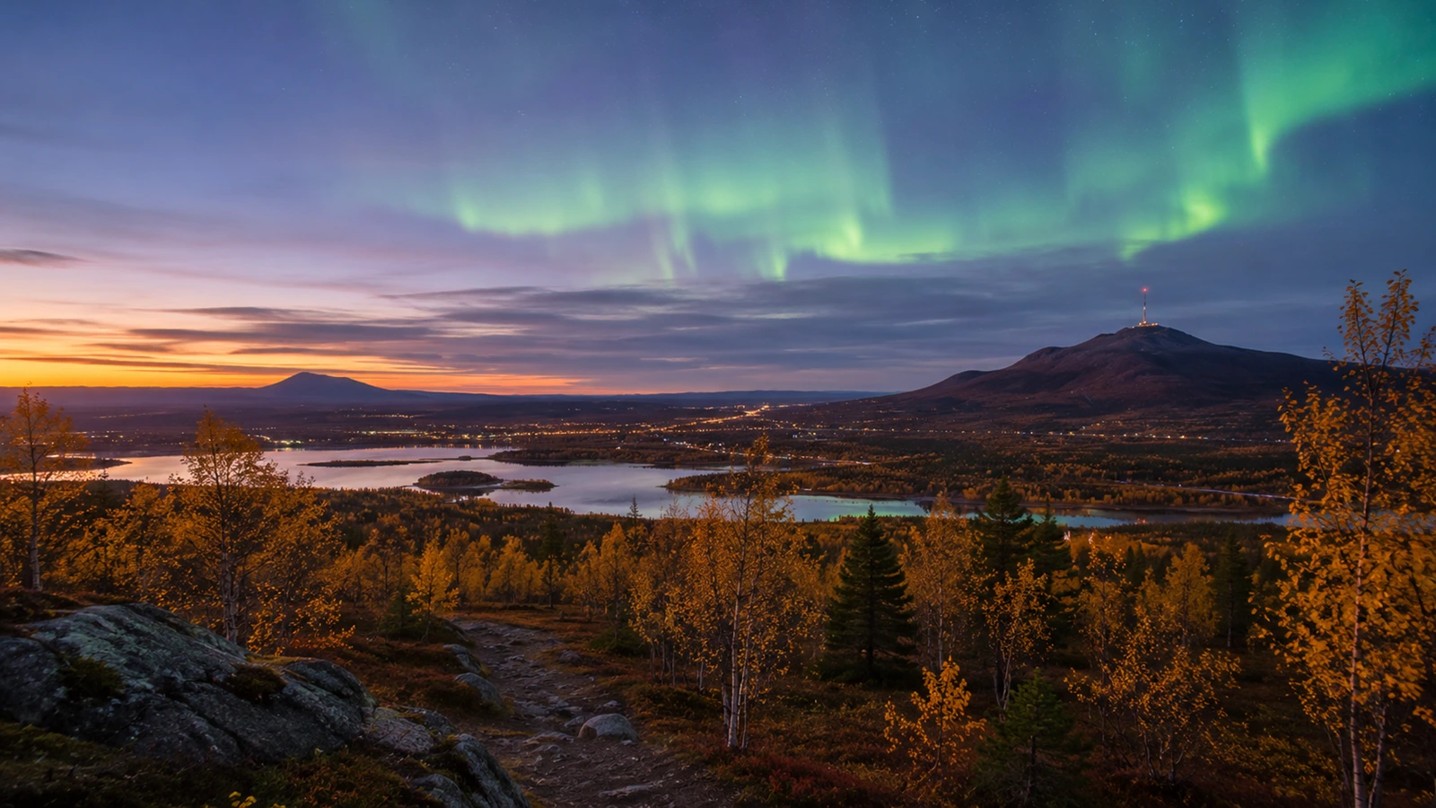 Golden birch trees, Arctic mountains and early Northern Lights in Kiruna during autumn