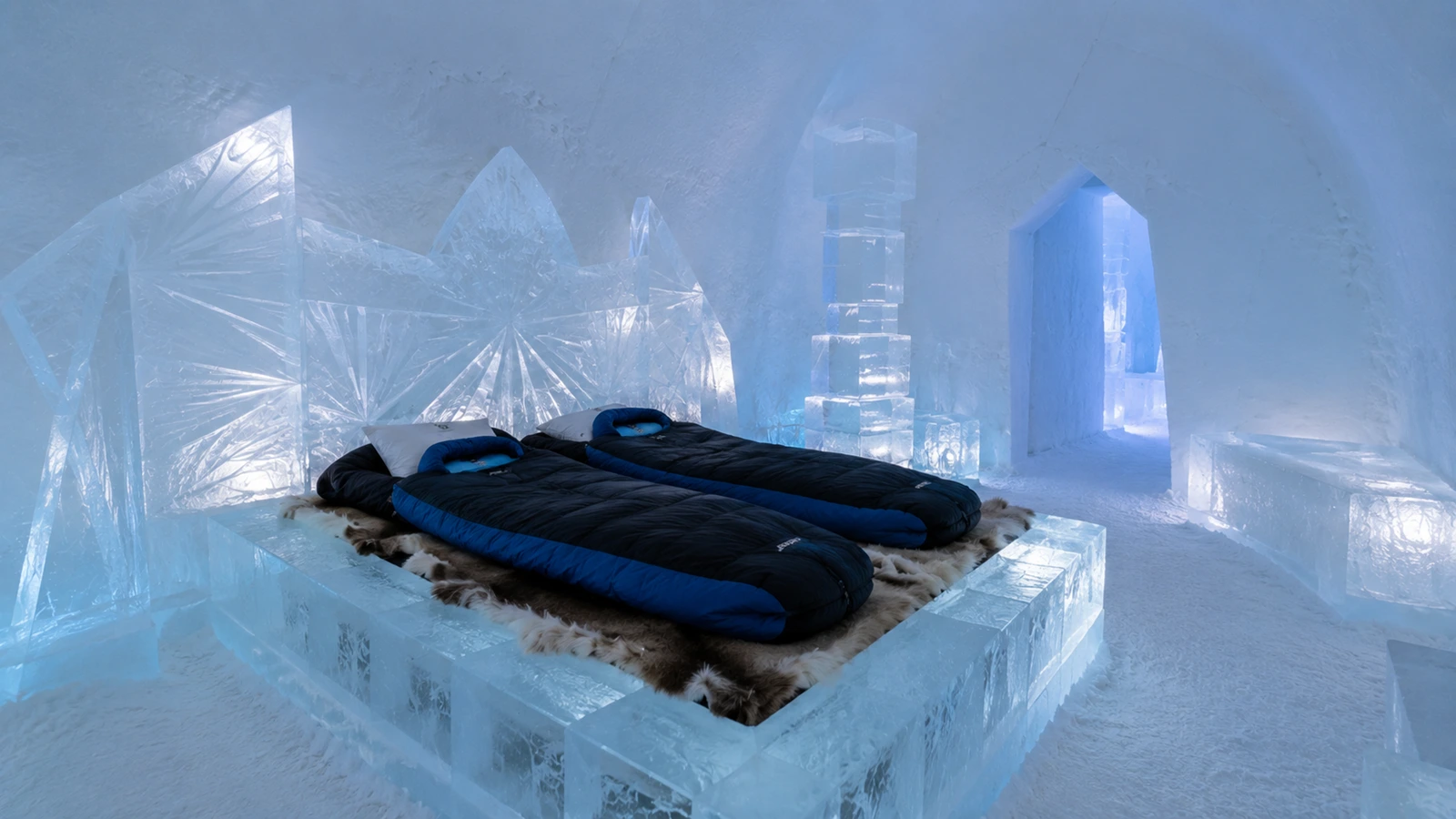 ICEHOTEL ice room prepared for overnight guests with thermal sleeping bags